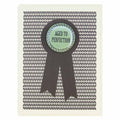 A birthday card with a black and white geometric pattern in the background. A large black ribbon graphic is overlaid, and centered on it is a round, mint green button with a white scalloped edge. The button reads "AGED TO PERFECTION" in black text.
