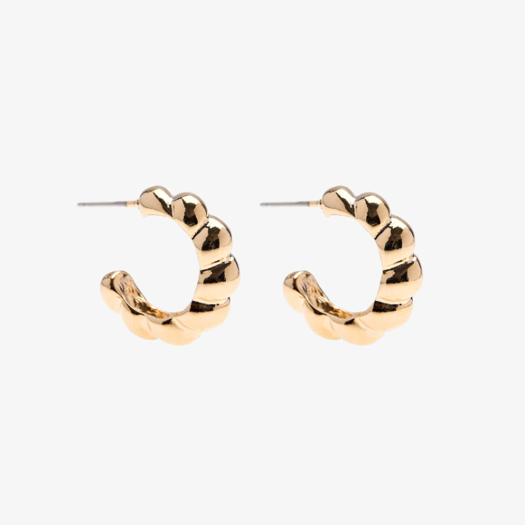 Gold hoop earrings on a white background