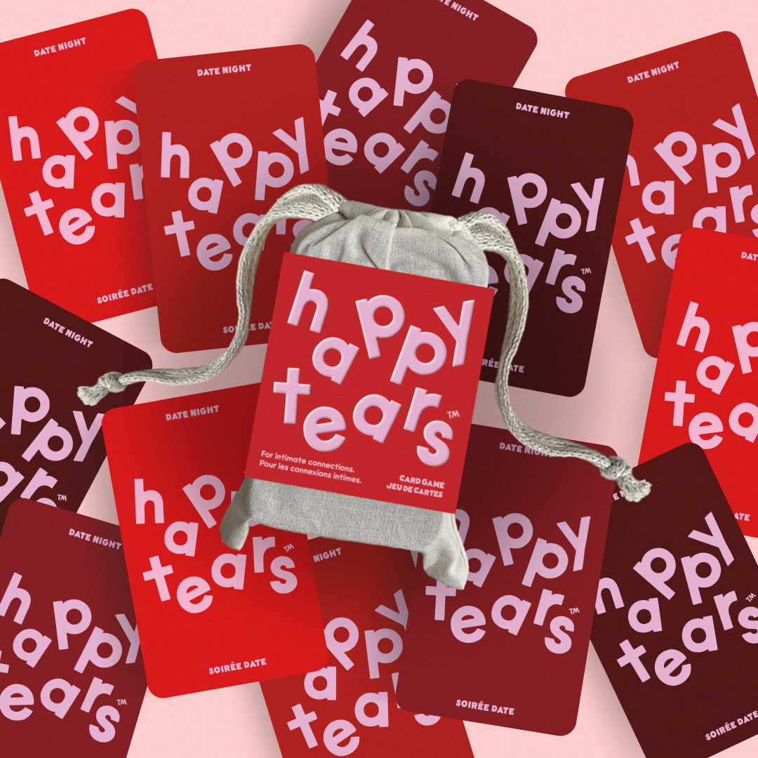 Happy Tears Intimate Connections card game, Ottawa. Red conversation cards in grey drawstring bag. 'Happy Tears' logo, bilingual text: 'For Intimate connections', 'Pour les connexions intimes'. Fun card game for couples.