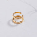Gold ring on a light gray background