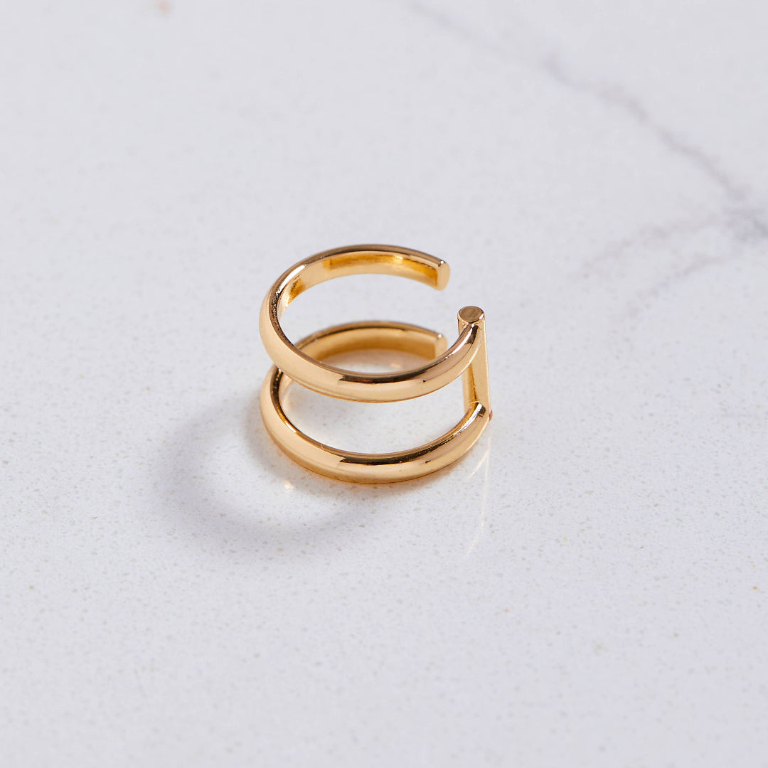 Gold ring on a light gray background