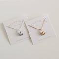 Two necklaces on display cards with 'Burch Jewellery' branding on a light background.
