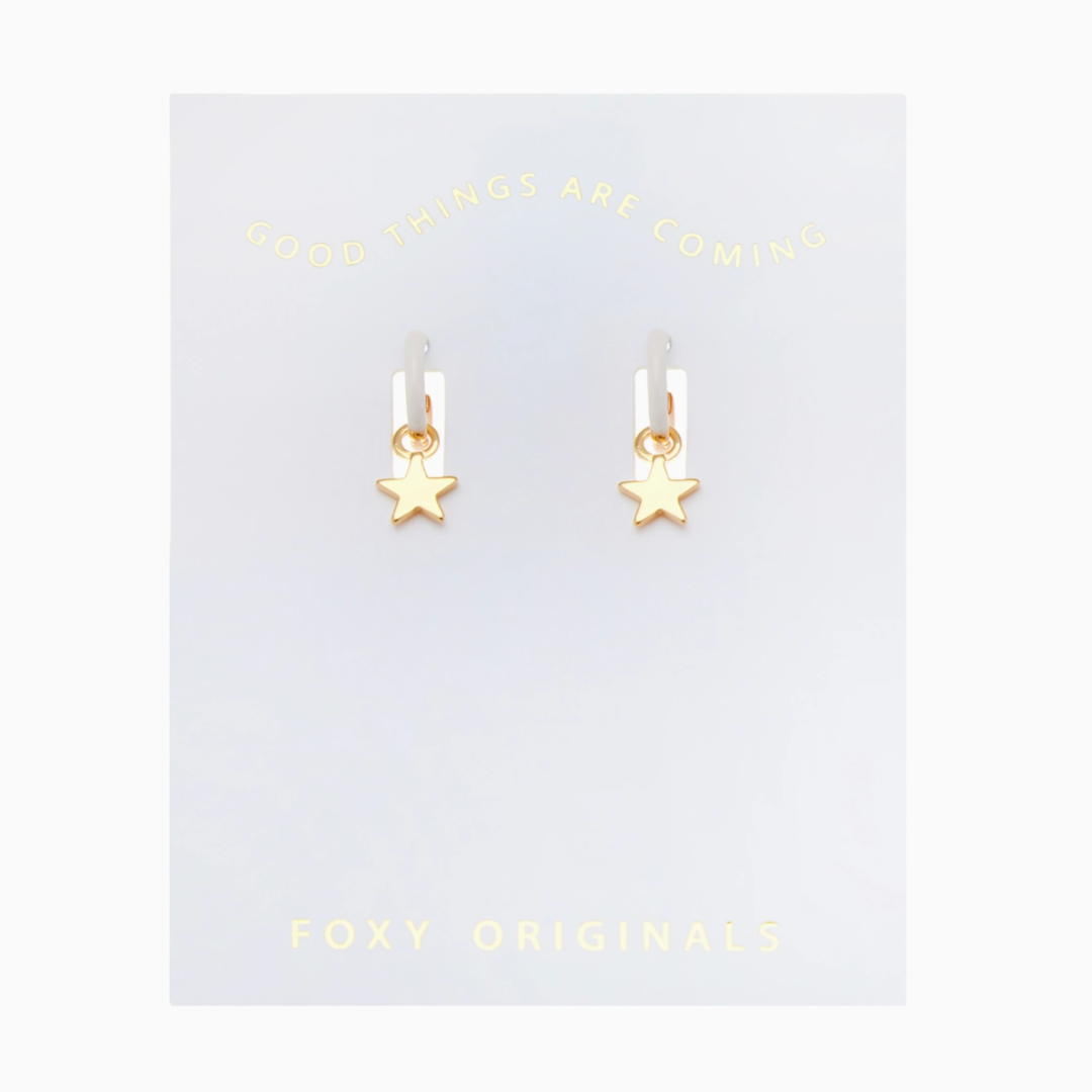 Gold star earrings on a 'Foxy Originals' branded card with text above.