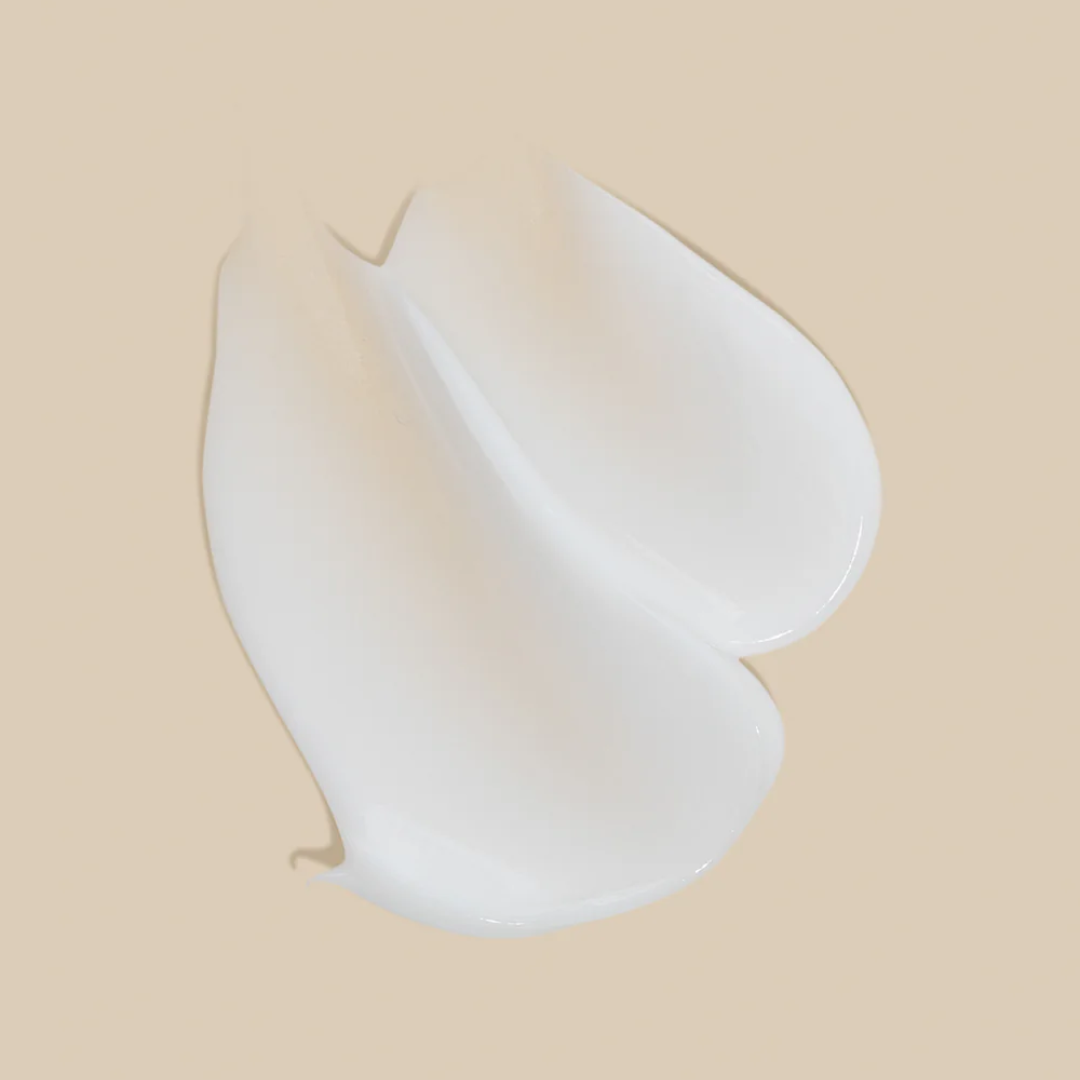 white lotion spread across a beige background.