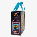 A black reusable tote bag with bright neon blue, pink, and yellow graphics. The front features a large cocktail glass with a cherry and straw, and text that reads "IS IT THE LAST CALL? OR IS IT THE FIRST DRINK OF THE REST OF OUR LIVES?!". On the left side, part of a neon bottle graphic is visible.