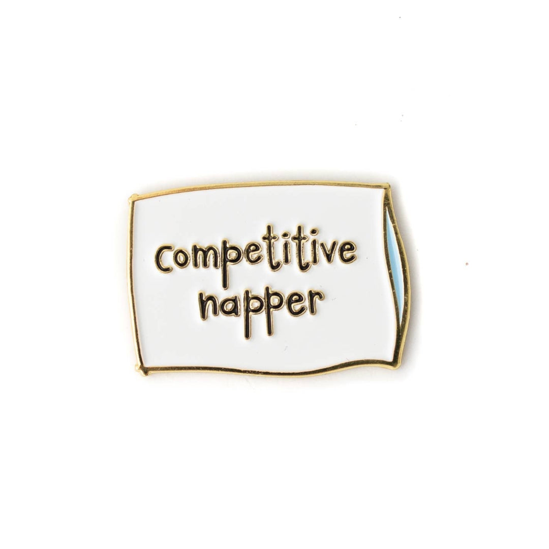 Enamel pin with 'competitive happer' text on a white background