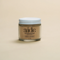 Aide Bodycare Rejuvenating Face Mask in a small glass jar with a white lid and a label with 'aide' logo, 'Rejuvenating Mask', and 'neroli lavender' text, displayed on a light-colored surface. The mask is natural and available in Ottawa, Ontario, Canada.