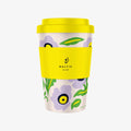 Reusable coffee cup with floral design and yellow lid on a white background