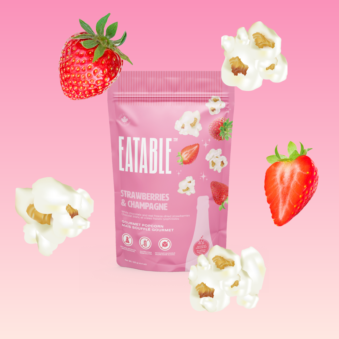 Eatable product packaging with strawberries and popcorn on a pink background