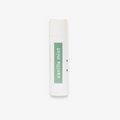 A white tube of lip balm with the word "vanilla mint" printed in green on the label.