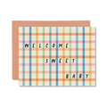 Greeting card with plaid pattern and text 'Welcome Sweet Baby' on a white background