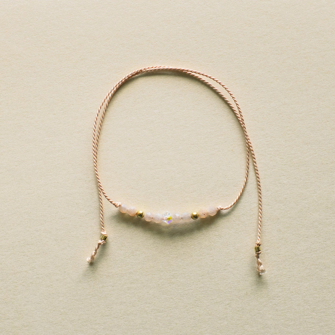Delicate bracelet with small beads on a beige background